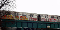 nyc-subway:  Rare sight of graffitied train resting above Brooklyn