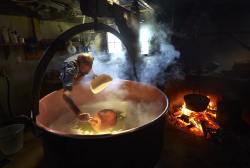 Curds and whey (cheesemaker Jacques Murith toiling at his craft near Lac de la Gruyère, Switzerland)