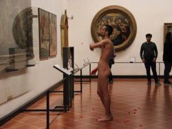 relijion:  A naked Spanish men throws flower petals at the picture