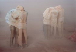 unrar:    Refugees in the desert. People engulfed in a sandstorm