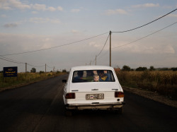 20aliens:SERBIA. 2008. A boy rides with his family in a Zastava