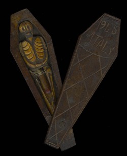 A WWII trench art coffin with a skeleton inside. The coffin lid,