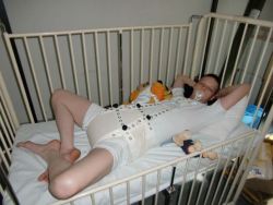 rubbermayhem:  Bobby was getting out of his crib at night so Daddy got some new restraints to keep him safe and secure. 
