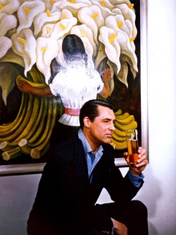 updownsmilefrown:Cary Grant sitting in front of his painting,