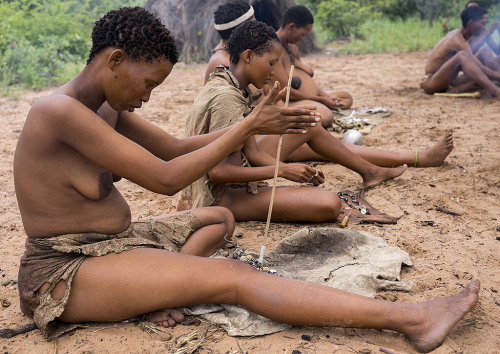 Bushman Women Making Necklaces With Ostrich Eggs Shells, Tsumkwe, Namibia, by Eric Lafforgue.