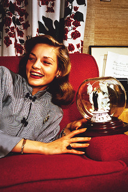  Lauren Bacall holding a globe containing her and Bogie’s bride