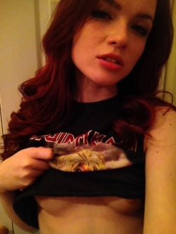 Heraxo rocking some band merch and showing off some underboob