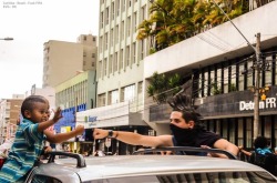 ragemovement:  Protester fist bumps child over a truck during
