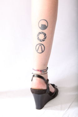 fuckyeahtattoos:  Gaming ink! Black Mesa, Aperture, Vault symbol. 