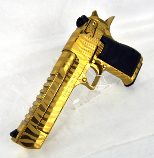 gunrunnerhell:  Golden Tiger Current generation Desert Eagle Mark XIX in the golden tiger stripe finish. Definitely an eye catching finish but not something for everyone. The gold finishes require a bit more maintenance and care than the matte black and