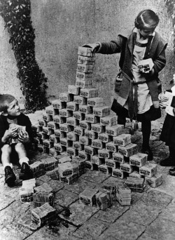 German children play with stacks of near-worthless money during