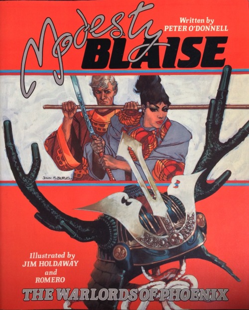 Modesty Blaise: The Warlords of Phoenix, written by Peter O’Donnell, illustrated by Jim Holdaway and Romero (Titan Books, 1986). Cover art by John M. Burns.From Oxfam in Nottingham.