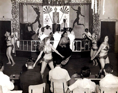 A vintage 50’s-era candid photo, captures showgirls shakin’-it-up on an unidentified nightclub dance floor; somewhere in Cuba..