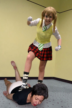 Slave Pia beaten up, stomped and posed over by a victorious teen cosplayer