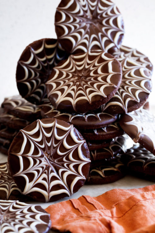 sweetoothgirl:  Chocolate Dipped Spiderweb Halloween Cookies