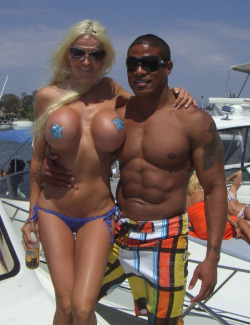 Sexy MILF goes topless sailing, covering her massive fake tits