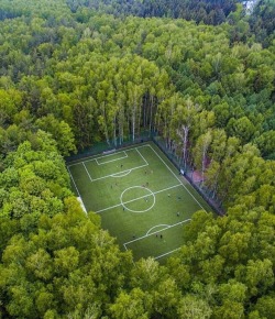 sixpenceee:  Drone shot of a soccer field in the middle of the