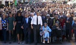 guardian:   President Barack Obama holds hands with Selma march