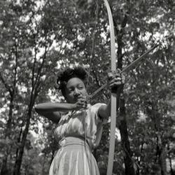 Loretta Gyles of the Methodist Camp Service pulling a bow, 1943.