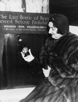  Rae Samuels holds the last bottle of beer that was distilled