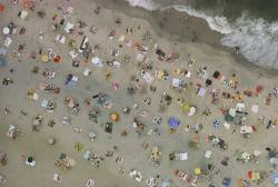 natgeofound:  Aerial view of seaside sunbathers encamped on beach