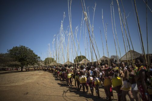     Zulu women at the reed dance. Via The Guardian.   As part of the ceremony, the young women dance bare-breasted for the king, each carrying a long reed, deposited later as they approach him.  