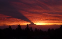 Breaking the dawn (the sun rises behind Mt. Rainier, Washington,