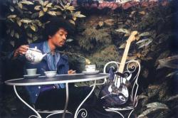 theswinginsixties:  Jimi Hendrix has tea with his guitar, 1960s.