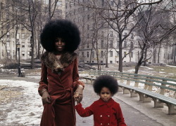 historium:  70’s style. Mother and daughter taking a walk in