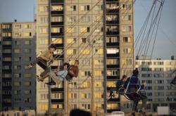 unrar:  Young Czechoslovakians ride swings on a visiting carnival