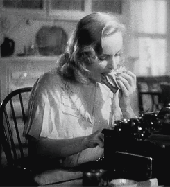 Carole Lombard enjoying a sandwich in True Confession (1937)