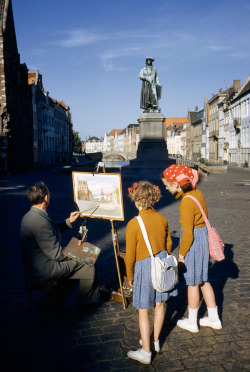 natgeofound:Girls watch artist painting picture of statue of