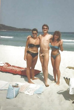 couplespublicerection:  This is one of those clothed females naked male posts, but I like the shot everyone is happy especially the lucky guy in the middle.  Itâ€™s a bit of a vintage shot given the hair styles and the swimsuits, so I think it is cool