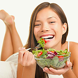 Women laughing alone with salad   