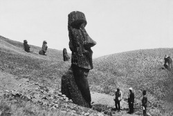 natgeofound:  Men observe the giant statues of Easter Island