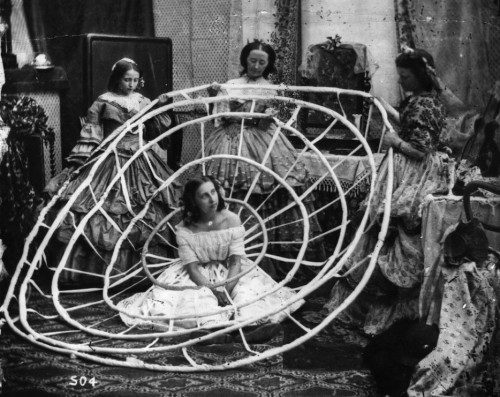 And you thought you had trouble getting dressed … (seamstresses in 1860 working on finishing a young woman’s crinoline)