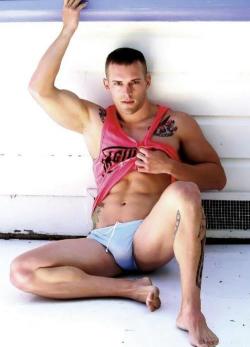 doylelee1760:  SEXY MODEL SITTING ON FLOOR POSES IN HIS SPEEDO