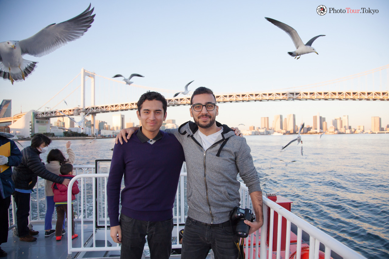 <p>Cousins doing on-location photography in Tokyo with PhotoTour.Tokyo. Photobombed by seagulls and rainbow bridge in background.</p>