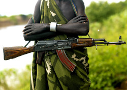 45-9mm-5-56mm:  Addicted to Kalachnikov - Mursi Ethiopia by Eric