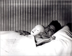 maudelynn:  “Cocteau in Bed with Mask.” by Berenice Abbott