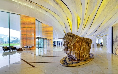 Epitome of opulence (the newly opened Sheraton Huzhou Hot Springs Resort towers over Taihu Lake, near Shanghai. Its lobby is floored in Afghanistan white jade and the lobby ceiling is hung with lamps made of 20,000 Swarovski crystals)