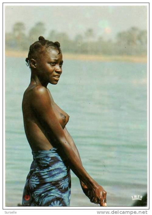 A stunning African girl bathing. See more on Native Nudity.