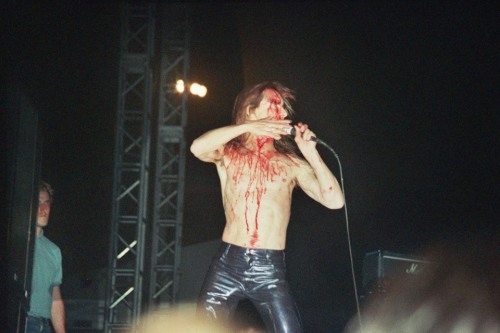 theunderestimator-2:  theunderestimator-2:  Iggy Pop covered in blood during his wild performance at the “Rock Of Gods” festival, held at the port of Piraeus, Greece, in 1996 (photos by Giorgos Mouratidis). While performing, Iggy got hit with a bottle