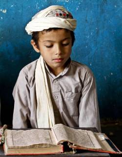  A boy reads verses of Quran at a mosque in Kandahar, Afghanistan