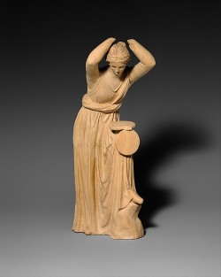 ancientpeoples:  Terracotta statuette of a woman looking into