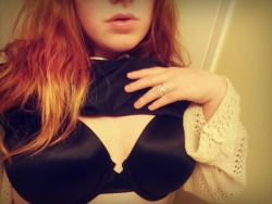 Black bra, pale skin.