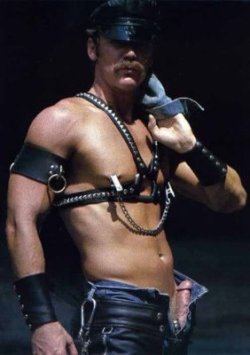 Leather guy with clamped nipples.  For more gay nippleplay, visit