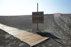inothernews:  OF THE TIMES   A sign marked a beach closed in