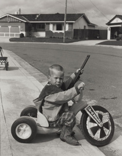 Richie playing with guns photo by Bill Owens, Suburbia series,