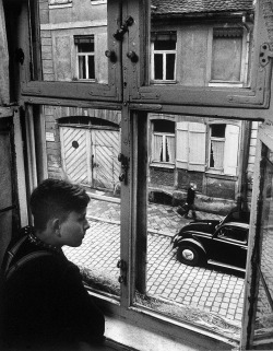 Boy looking out of window, Ansbach, Germany photo by Carl Mydans,